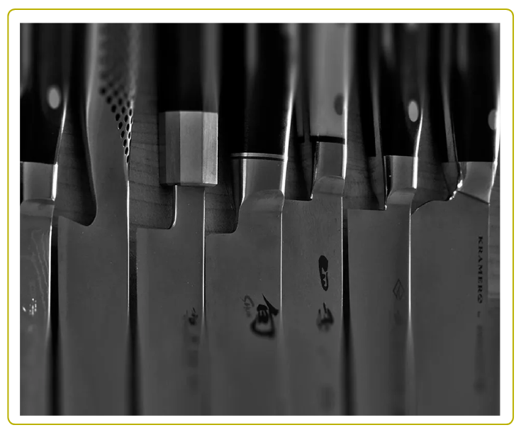 A row of knives hanging on the wall.