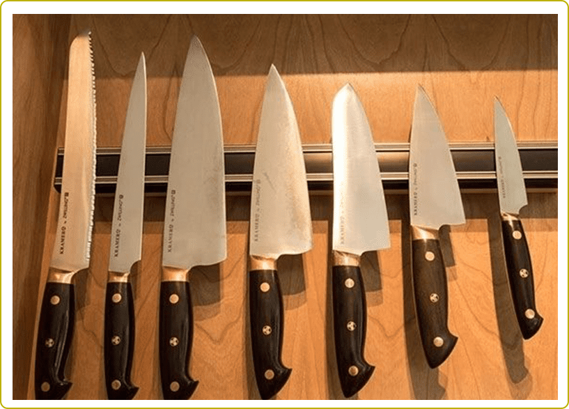 A row of knives hanging on the wall.