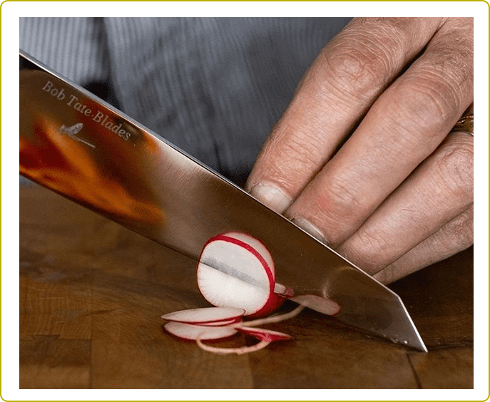 A person slicing onions with a knife.