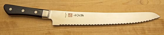 A knife with an asian design on it.