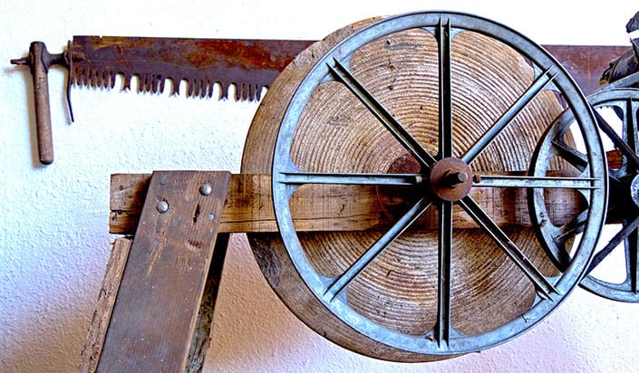 A wooden wheel with metal wheels on it.